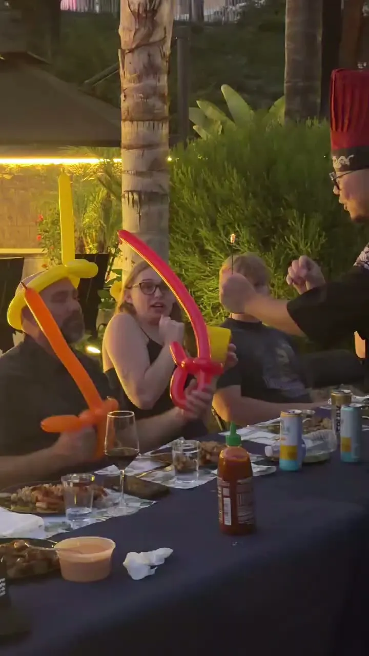 Video of guests with balloon hats having fun at a Real Hibachi sunset dinner