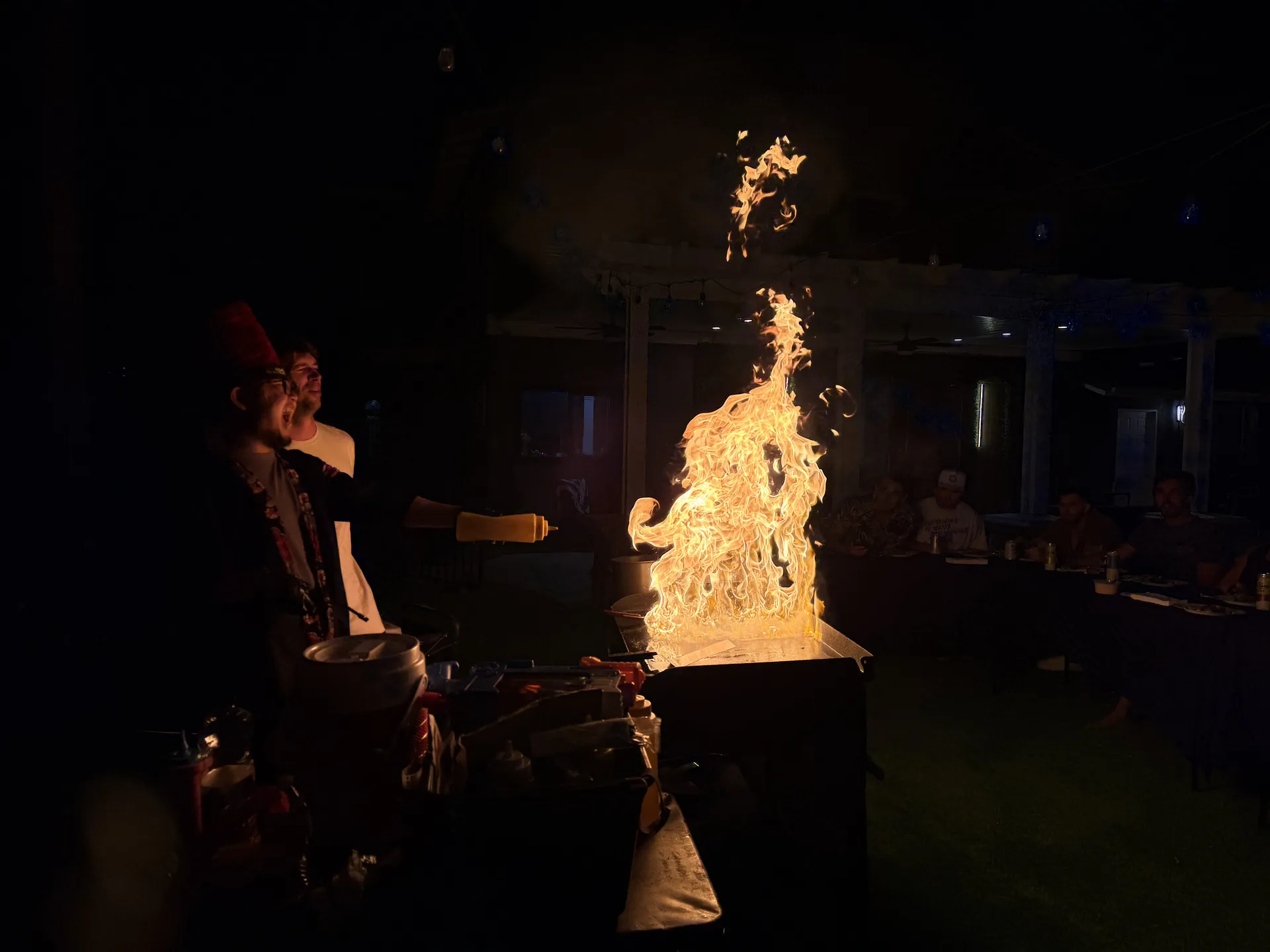 Huge hibachi flame lighting up a night birthday party