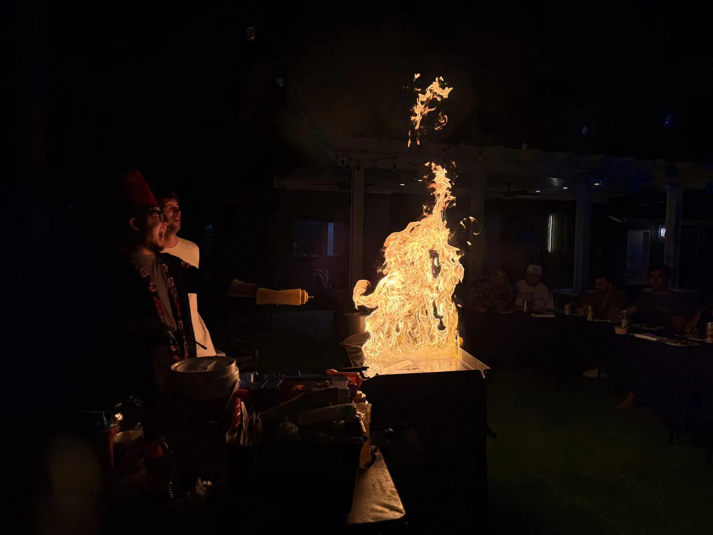 Night hibachi fire show at a backyard party