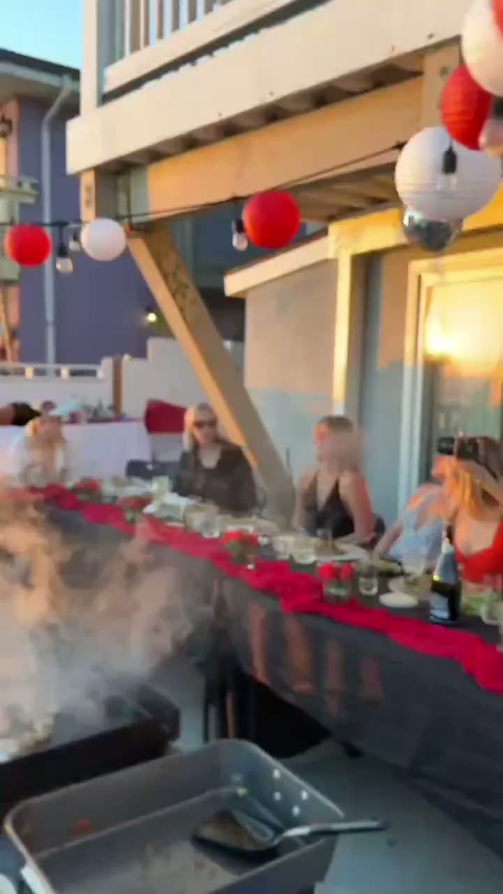 Video of an oceanfront sunset hibachi dinner party with lanterns in Southern California