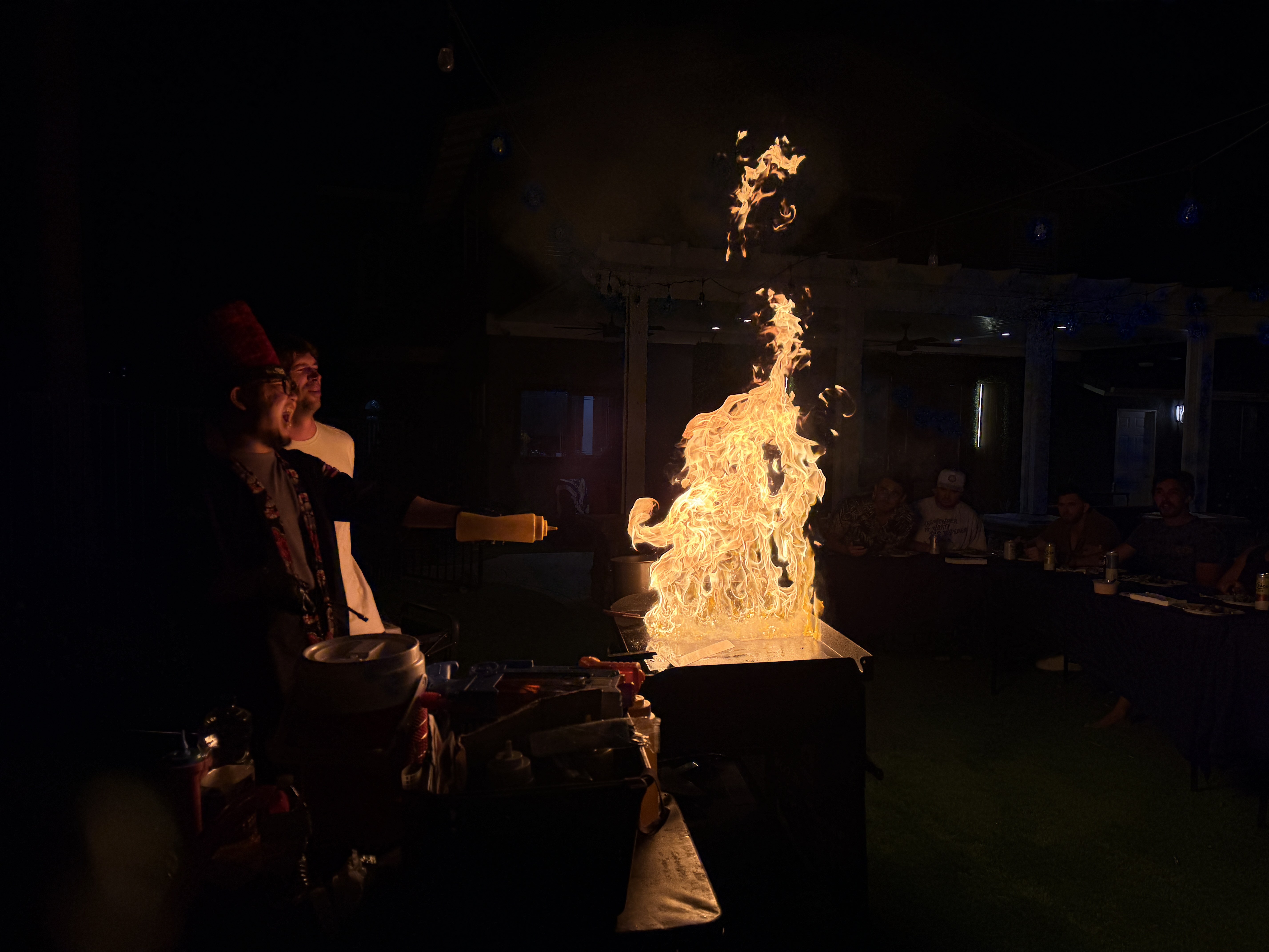 Huge hibachi flame lighting up a night birthday party